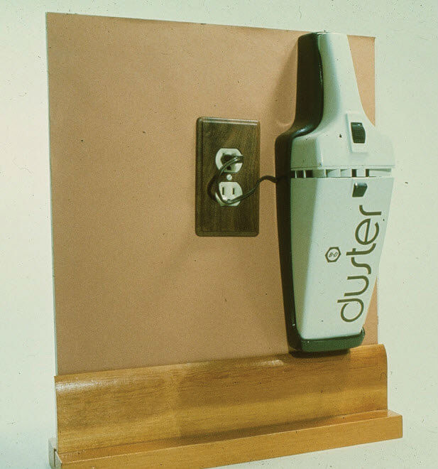 Image: A later prototype for the Dustbuster, showing it plugged into a wall