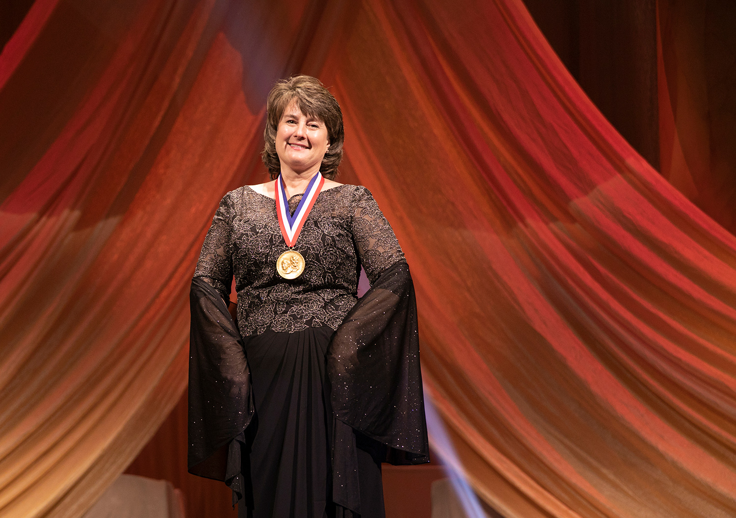 Jackie Quinn smiles with a medal on at the 2018 National Inventor Hall of Fame Induction Ceremony