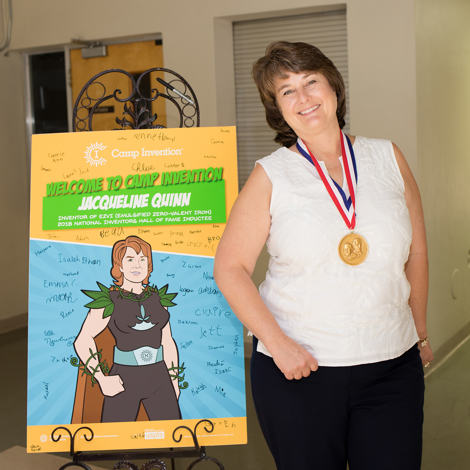 Jackie Quinn poses with her Camp Invention poster, autographed by campers
