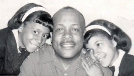 Marian Croak smiles as a child with her father and sister