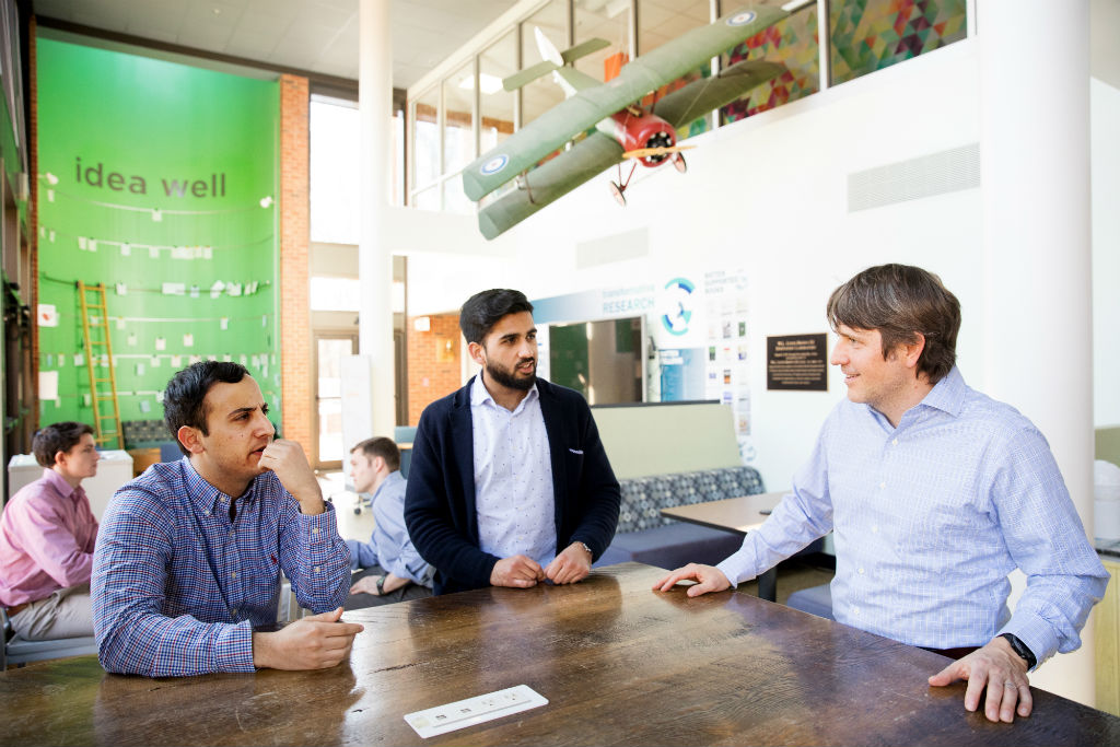 From left, Payam Pourtaheri and Ameer Shakeel visit with Jason Brewster, the incubator program director at University of Virginia i.Lab. As a startup at the incubator, AgroSpheres received initial funding, access to mentors, and a workspace.