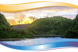 Photo of tropical location with blue water, yellow sunset and wind turbines along the skyline. 