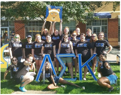 Group of college students in black t-shirts with greek letters standing for Alpha Sigma Kappa 