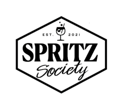A hexagon with the word “SPRITZ” in the center in large font. The word “Society” appears in cursive beneath and at the top of the hexagon is a martini glass in between the text “EST.” and “2021.”