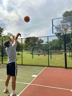 Travis shooting a basketball and demonstrating how the Follow Thru Fixer works